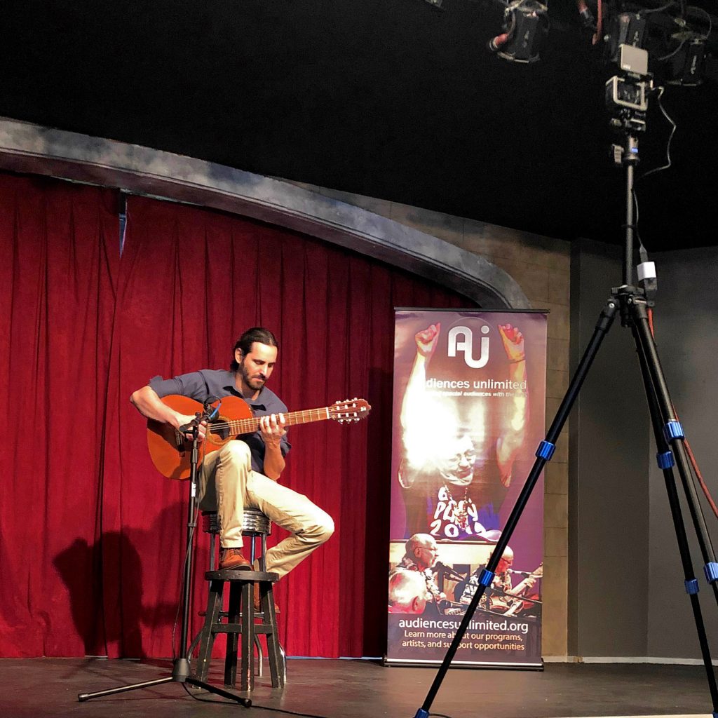 A performer records a show onstage for video programs
