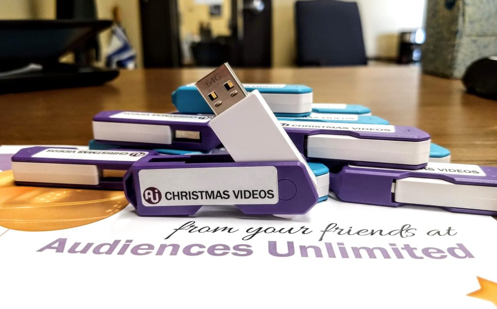 Picture of flash drives labeled "Christmas videos"