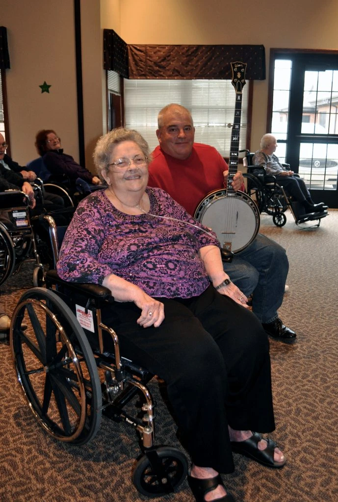 A woman in a wheelchair enjoys a performance.