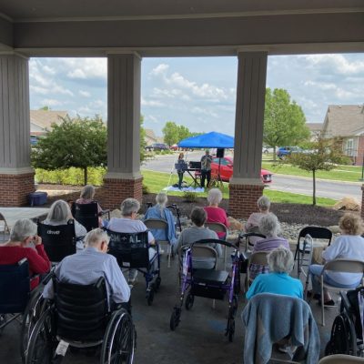 Musicians perform for a crowd of residents outdoors