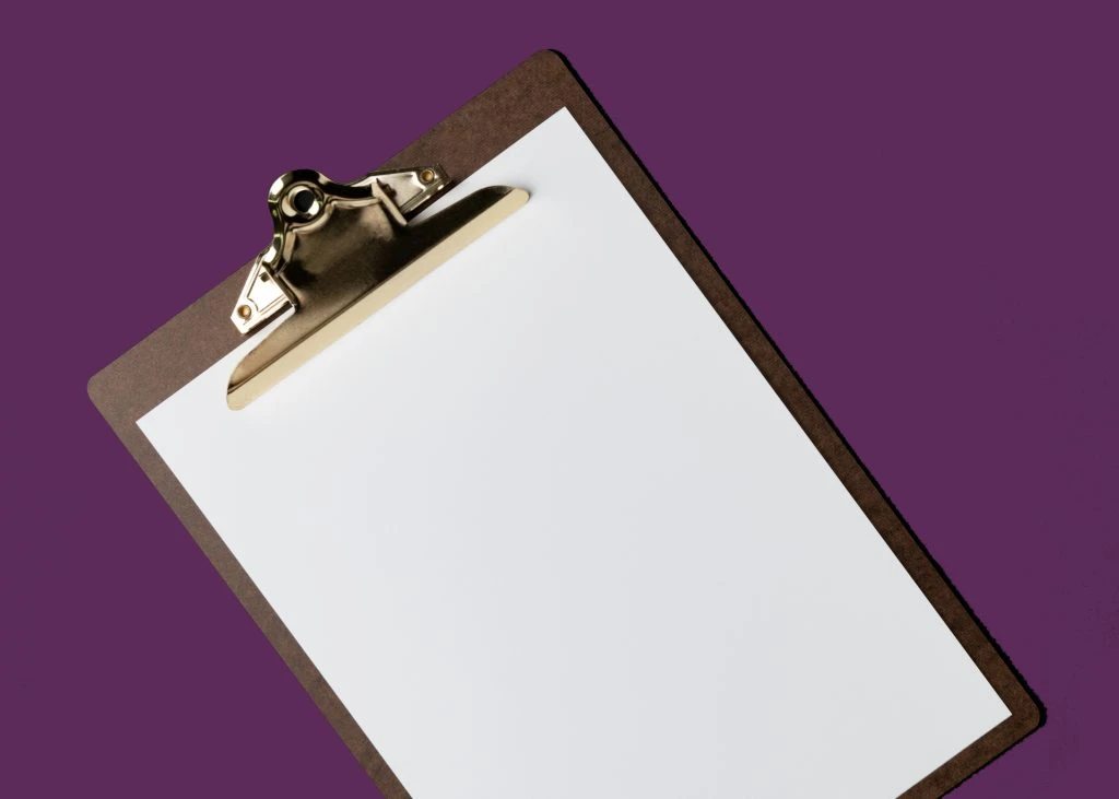 Blank white paper on brown clipboard, flat lay